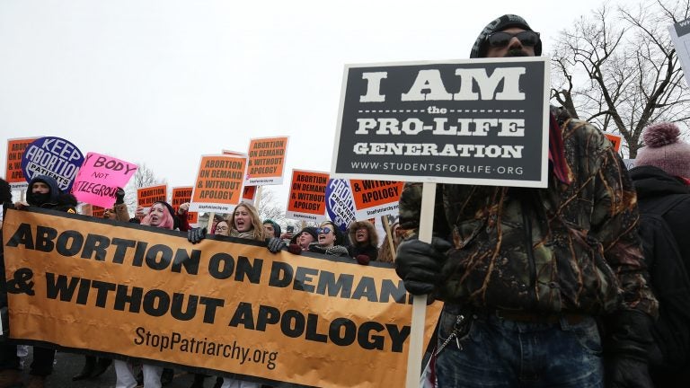 Dueling protesters at a March for Life rally in 2016. Only 17 percent say they want the landmark Roe v. Wade ruling overturned, a new NPR/PBS NewsHour/Marist poll finds. (Alex Wong/Getty Images)