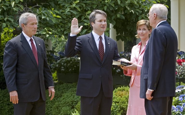 Brett Kavanaugh is sworn in as a federal judge by Supreme Court Justice Anthony Kennedy in 2006. President George W. Bush looks on. Kavanaugh is Trump's pick to replace Kennedy on the Supreme Court.