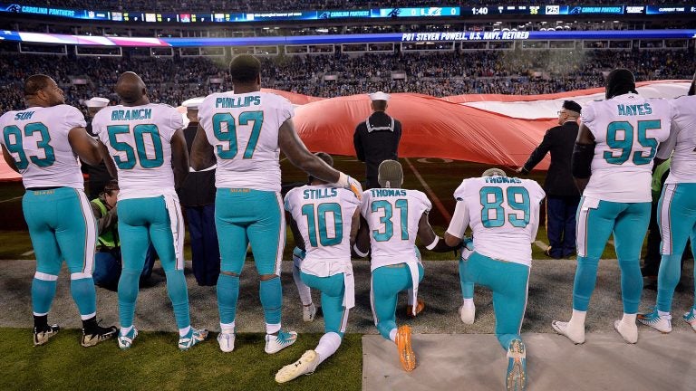 Miami Dolphins players kneel during the national anthem before their game against the Carolina Panthers at Bank of America Stadium on Nov. 13, 2017, in Charlotte, N.C. (Grant Halverson/Getty Images)