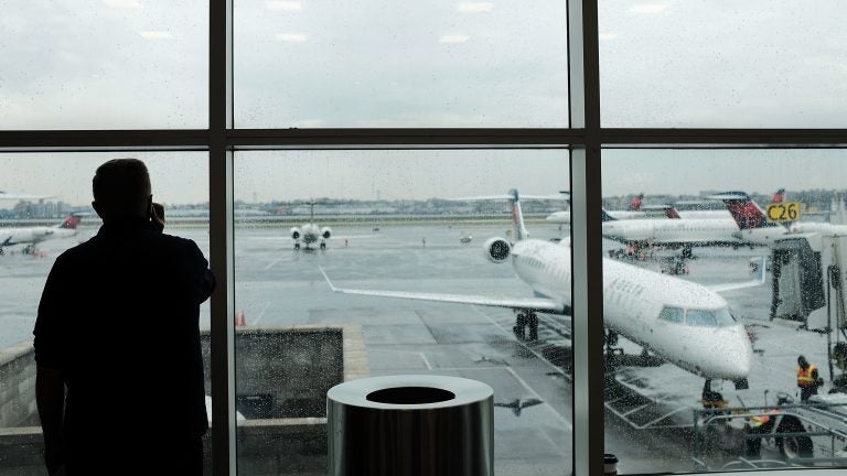A passenger looks over planes sitting on the tarmac at LaGuardia Airport in New York City on Nov. 22. A previously undisclosed TSA program flags passengers for observation, and undercover air marshals observe their behavior — including whether they make calls or send texts as they travel, The Boston Globe reports. (Spencer Platt/Getty Images)