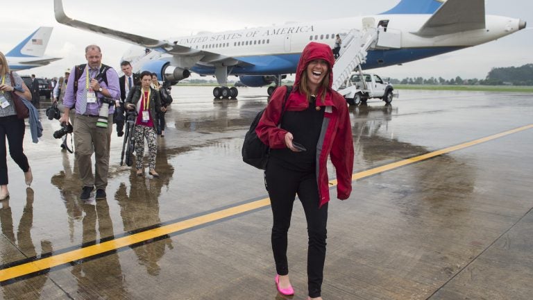 Beck Dorey-Stein, a former White House stenographer, walks with members of the White House press pool from Air Force One upon arrival at Wattay International Airport in Laos in 2016. (Saul Loe/AFP/Getty Images)