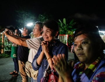 Onlookers watch and cheer as ambulances deliver boys rescued from a cave in northern Thailand to a hospital in Chiang Rai on Sunday.