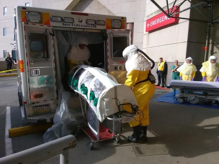 EMTs unload Parag S. Gohel from an ambulance at UPMC Presbyterian's ER. Gohel is in an isolation pod because he’s pretending to have an infectious disease for the hospital’s yearly drill. (Sarah Boden/WESA)