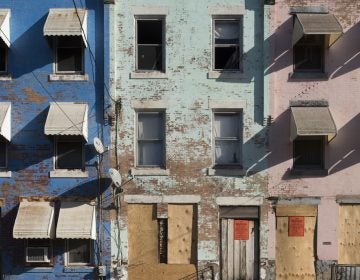 File photo: A row of houses, colorful but in need of substantial repairs, on North 27th Street in North Philadelphia.  (Jonathan Wilson for WHYY)