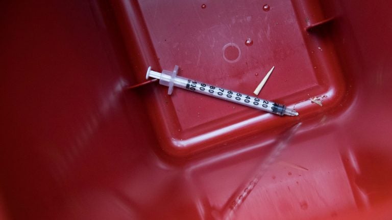 A used syringe is seen in a disposal container. (AP Photo/Mary Altaffer)