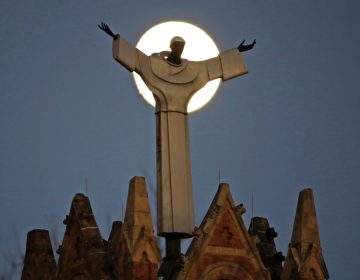 The moon rises behind St. Benedict The Moor Catholic church in Pittsburgh Saturday, Nov. 12, 2016. Pittsburgh is one of six Roman Catholic Dioceses that was the focus of a sealed grand jury investigation across Pennsylvania. (AP Photo/Gene J. Puskar)