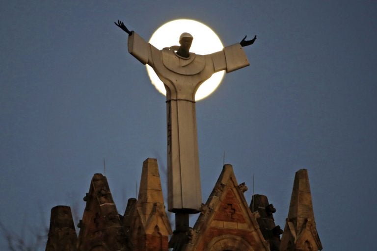 The moon rises behind St. Benedict The Moor Catholic church in Pittsburgh Saturday, Nov. 12, 2016. Pittsburgh is one of six Roman Catholic Dioceses that was the focus of a sealed grand jury investigation across Pennsylvania. (AP Photo/Gene J. Puskar)