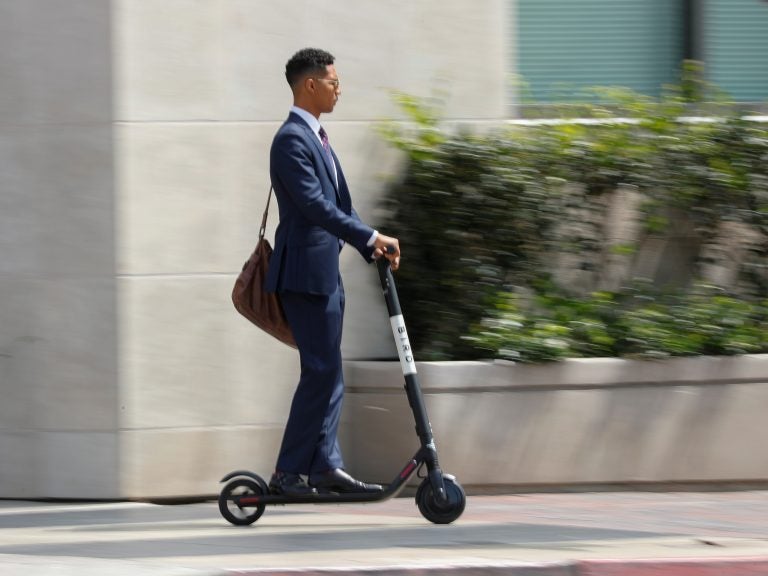 Electric scooters for rent are popping up in San Diego and other cities. Investors see a key role for them in getting from here to there. But many people find them downright annoying. (Mike Blake/Reuters)