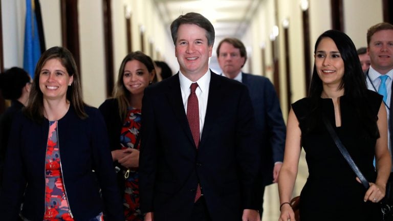 Supreme Court nominee Judge Brett Kavanaugh, center, arrives for a meeting with Sen. Jim Inhofe, R-Okla., Thursday, July 26, 2018, on Capitol Hill in Washington. (AP Photo/Jacquelyn Martin)