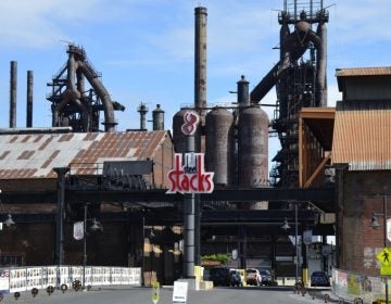A new “SteelStacks” sign adorns the old Bethlehem Steel Corp. blast furnaces. Behind the sign is a sparkling new complex with restaurants, a movie theatre and a large concert venue. (Jason Margolis/PRI)