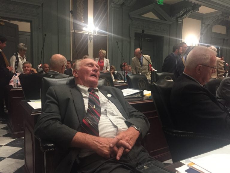 State Rep. Dave Wilson takes an understandable snooze about 7 a.m. on July 1 during a recess in this  year's final legislative session. (Cris Barrish/WHYY)