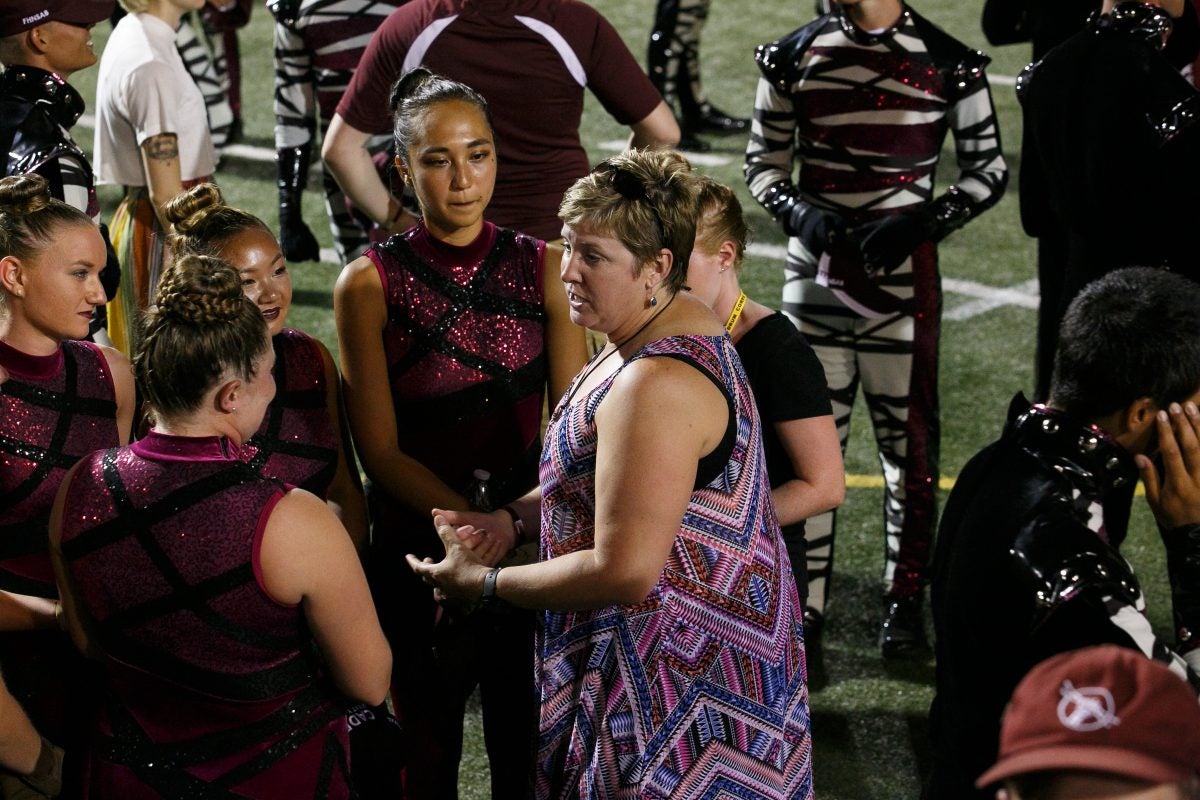 Former Cadet Kim Carter speaks with current members.