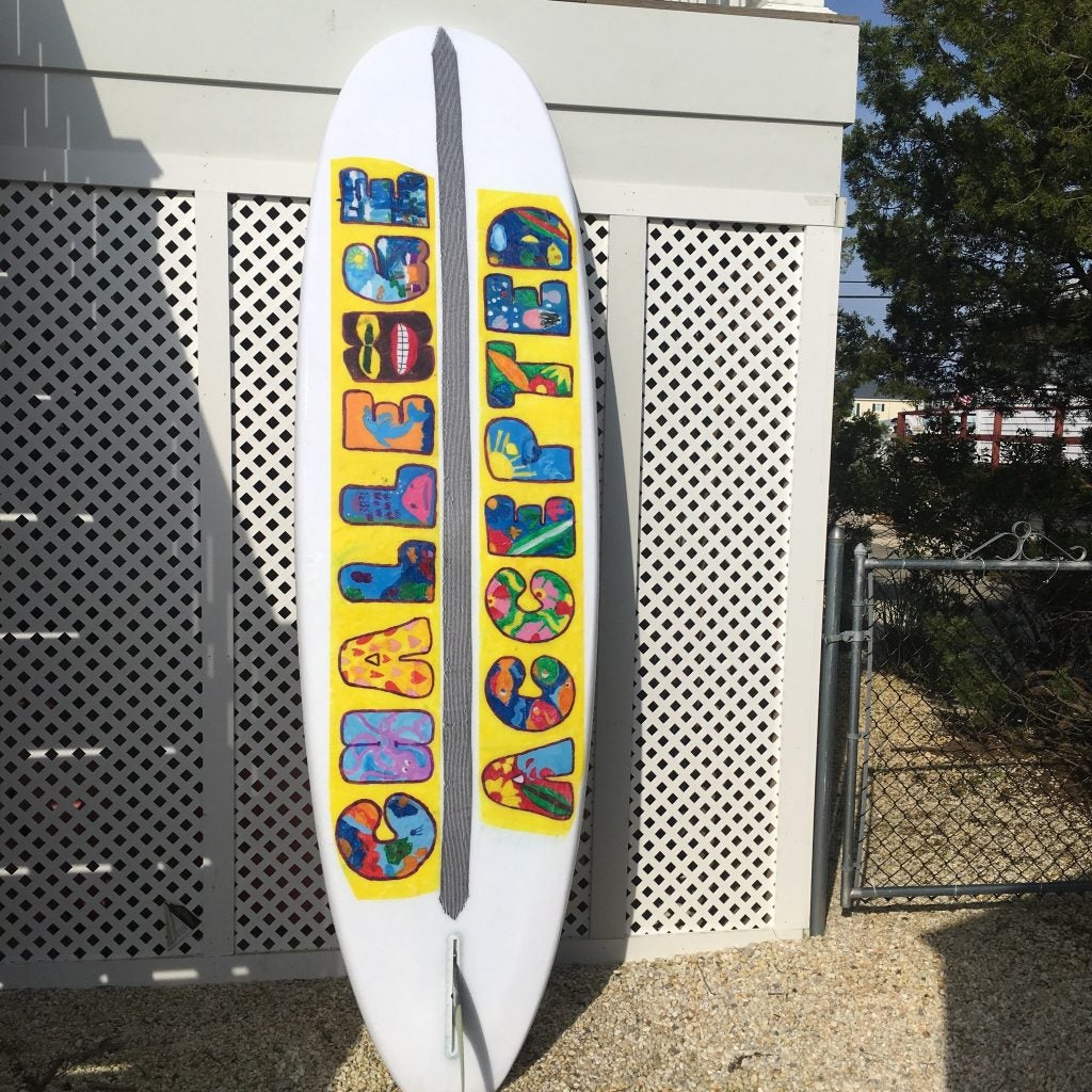 An adaptive surfboard designed/donated to MossRehab by surfboard shaper Luke Alvaraze with artwork designed by the students with disabilities at Carusi Middle School. Photo Credit: Alex Felts and Chelsea Bronstein