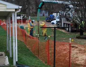 In this file photo from May, pipeline workers probe the ground on Lisa Drive in West Whiteland Township where sinkholes have developed as a result of the Mariner East 2 construction. (Jon Hurdle/StateImpact Pennsylvania)