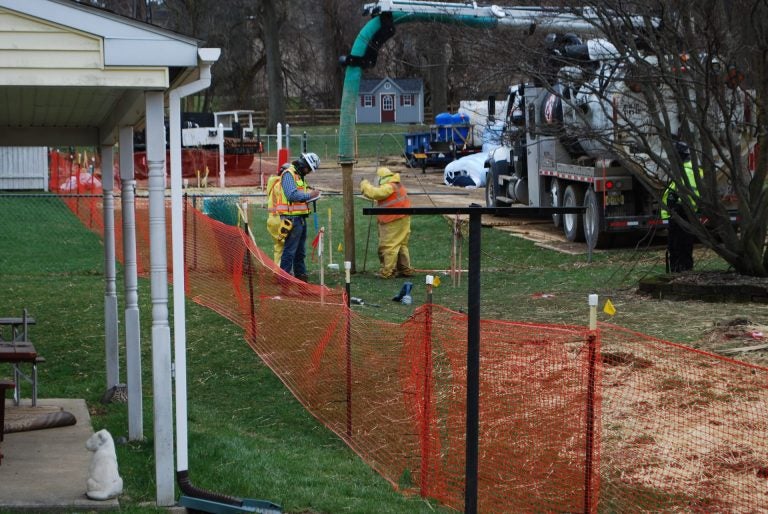 In this file photo from May, pipeline workers probe the ground on Lisa Drive in West Whiteland Township where sinkholes have developed as a result of the Mariner East 2 construction. (Jon Hurdle/StateImpact Pennsylvania)