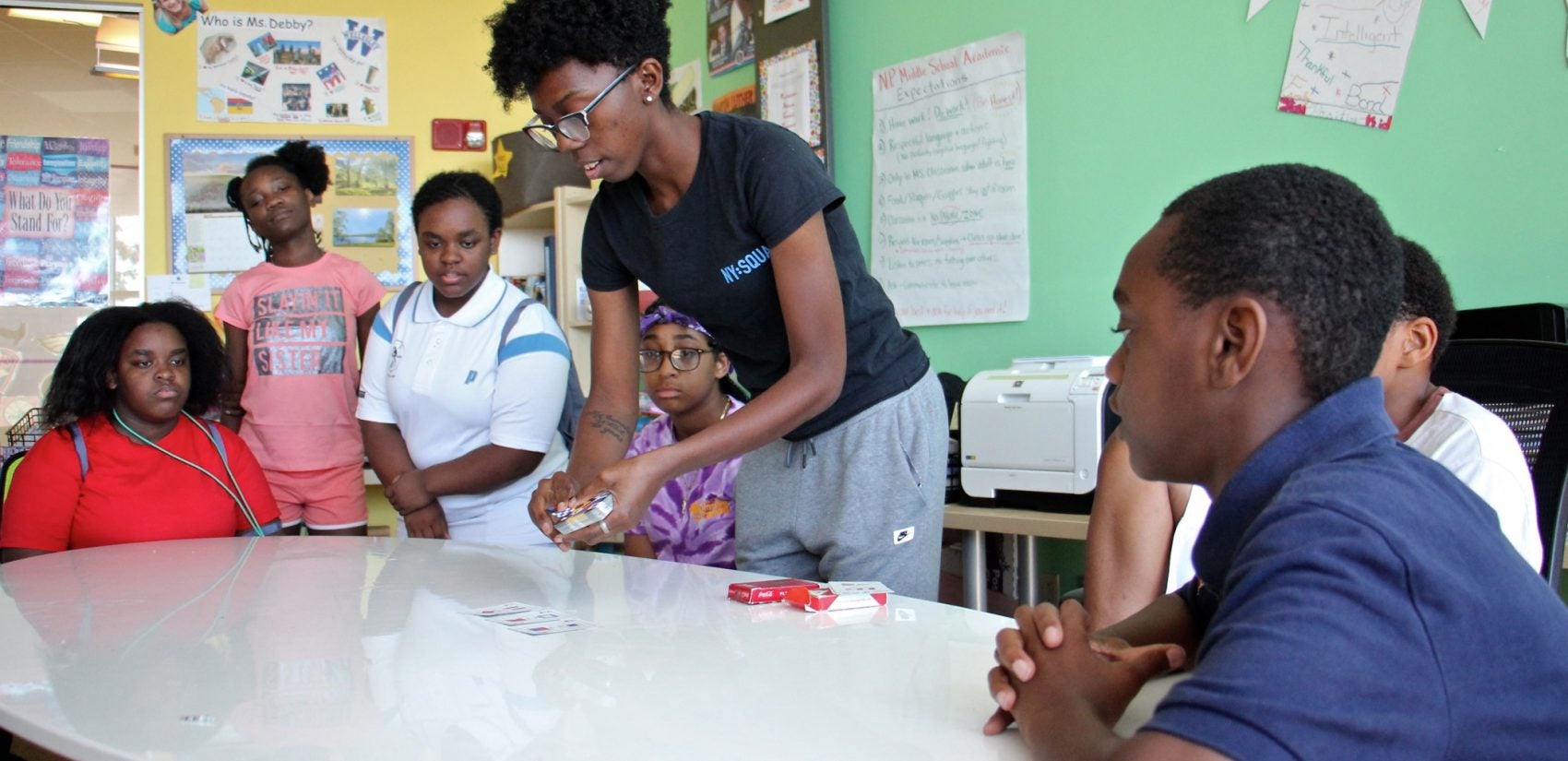 Quinetta Bowden, director of middle school academics at Squash Smarts, sharpens her students' math skills with a card game called 