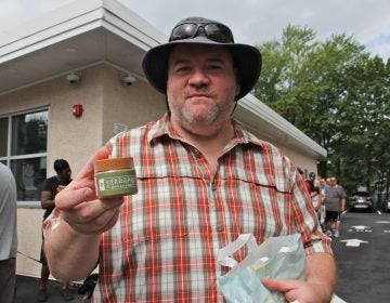 Thom ?? holds a container of dry-leaf marijuana, which was made available for sale at dispensaries in Pennsylvania for the first time. About 50 people lined up outside TerraVida Holistic Centers in Abington hours before the dispensary opened at 10 a.m.