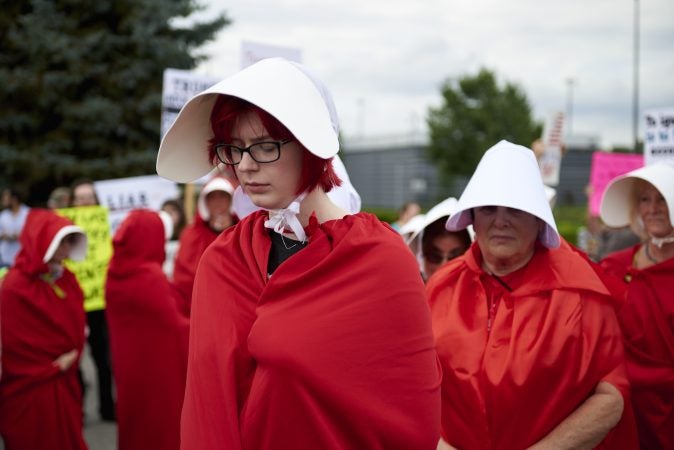 Alexis Yeager, 20, of Dallas, Pa., is a political science major at Misecordia University. She dresses as a Handmaid and attends her first protest. (Natalie Piserchio for WHYY)