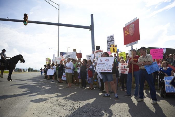 Police on horses gather a crowd of protesters towards the sidewalk on Highland Park Boulevard in Wilkes-Barre, Pa. Approximately 300 protesters showed up on August 2, 2018, outside of the Make America Great Again rally. (Natalie Piserchio for WHYY)