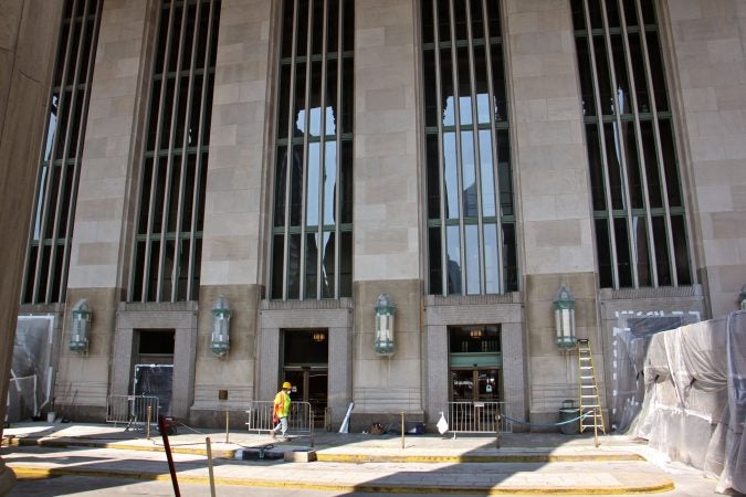 Beneath the East Portico of 30th Street Station, the cleaned limestone façade (top) can be compared with the lower, unrestored stone. (Emma Lee/WHYY)