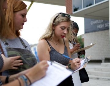 Young people register to vote outside a March for Our Lives gun control town hall at Universal Audenreid High School, in Greys Ferry