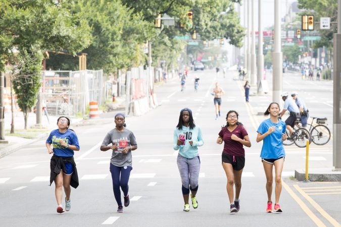 (From left) Linda Jiang, Nassira Doumbia, Kayla Murray, Zitlali Delacruz, and Michelle Wu run Broad Street together as a part of the group Students Run Philly Style on August 11, 2018. In speaking about Philly Free Streets, a program which closed down Broad Street, Wu says that the experience is 
