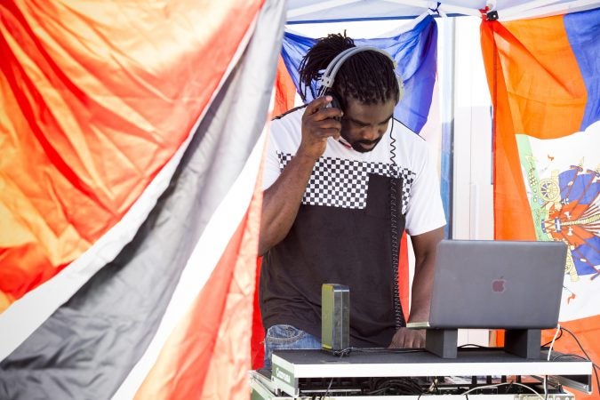 Roy Nurse DJs outside of Flambo Carribean Restaurant to draw customers in from Philly Free Streets on August 11, 2018. (Rachel Wisniewski for WHYY)