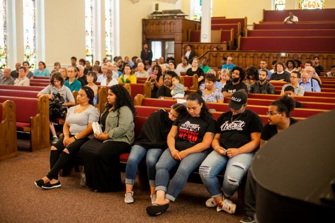 The family of Joseph Santos listens to speakers at a memorial service for the 44-year-old who was fatally shot on July 28, 2018 by South Whitehall Township Police Officer Jonathan Roselle. (Brad Larrison for WHYY)