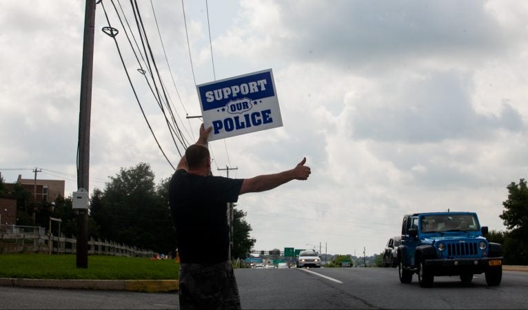 Supporters of South Whitehall Township Police Officer Jonathan Roselle gathered on Hamilton Boulevard where he fatally shot Joseph Santos, 44, of Hasbrouck Heights, N.J. on July 28, 2018. (Brad Larrison for WHYY)