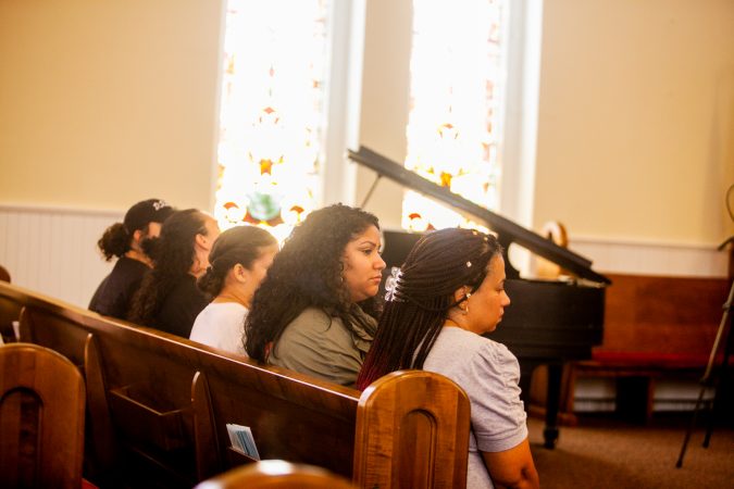 The family of Joseph Santos listens to speakers at a memorial service for the 44-year-old who was fatally shot on July 28, 2018 by South Whitehall Township Police Officer Jonathan Roselle. (Brad Larrison for WHYY)