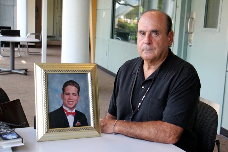 Arthur Baselice Jr. poses with a photo of his son, Arthur Baselice III, who was abused by two Franciscan clergymen in Northeast Philadelphia. Baselice III died of a drug overdose in 2006 at age 28.