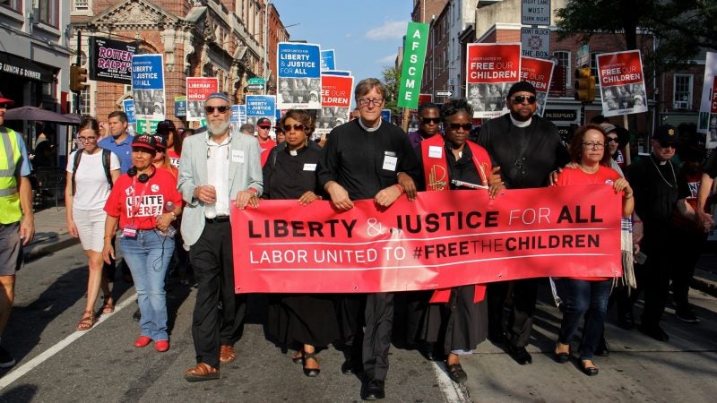 Thousands of union members march silently down Chestnut Street in support of immigrant families. (Emma Lee/WHYY)