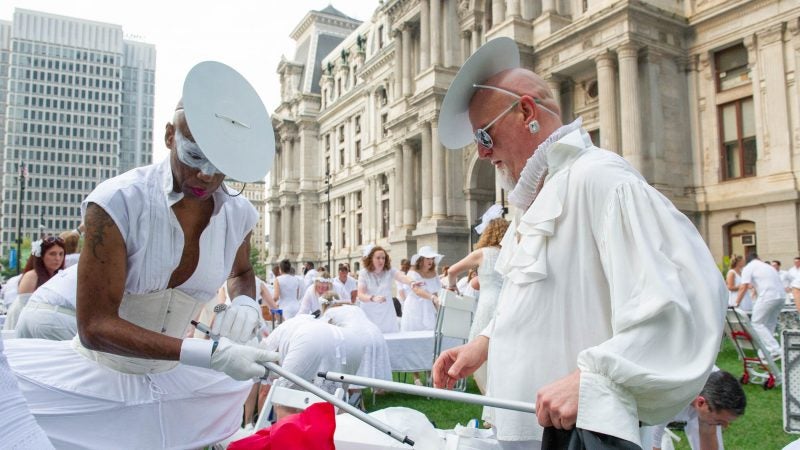 Joe Gray (left) and Don Maedche assemble a table at the start of Le Dîner en Blanc. (Jonathan Wilson for WHYY)