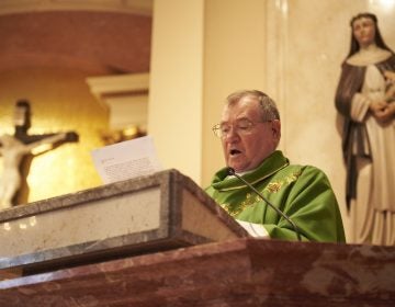 Monsignor Francis Schoenauer reads a letter from Allentown Bishop Alfred Schlert during Sunday mass at the Cathedral Church of St. Catharine of Siena in Allentown, Pa. (Natalie Piserchio for WHYY)