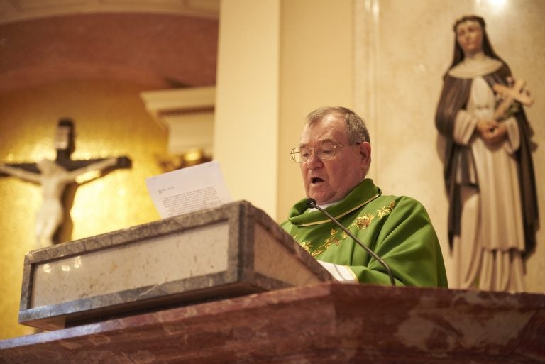 Monsignor Francis Schoenauer reads a letter from Allentown Bishop Alfred Schlert during Sunday mass at the Cathedral Church of St. Catharine of Siena in Allentown, Pa. (Natalie Piserchio for WHYY)