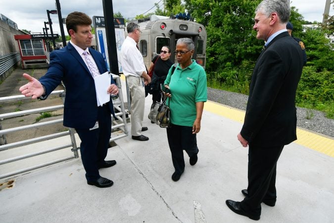 NJ Transit Executive Director Kevin Corbett (right) greets passengers returning from Atlantic City at the Lindenwold, N.J. station Tuesday. The agency held a listening forum for passengers to share their thoughts on the passenger rail service. (Bastiaan Slabbers for WHYY)