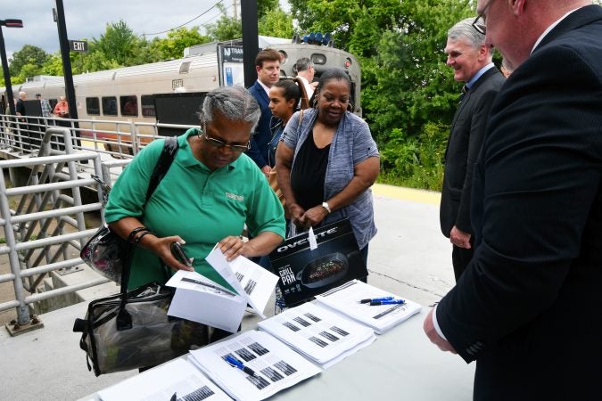 After departing the train, Tropicana Casino employee Renee Wilson, of Lindenwold, looks over information about the temporary suspension of the Atlantic City line for positive train control or PTC installation. (Bastiaan Slabbers for WHYY)