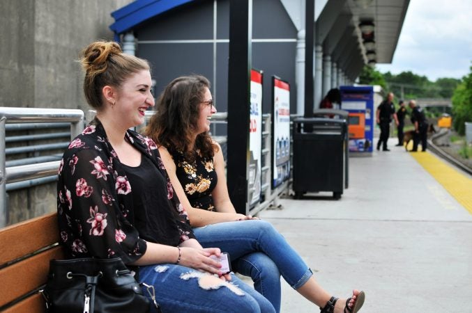 Jenna DeLuca waits with a friend for a train to Atlantic City Monday at the Lindenwold, N.J. station. (Bastiaan Slabbers for WHYY)