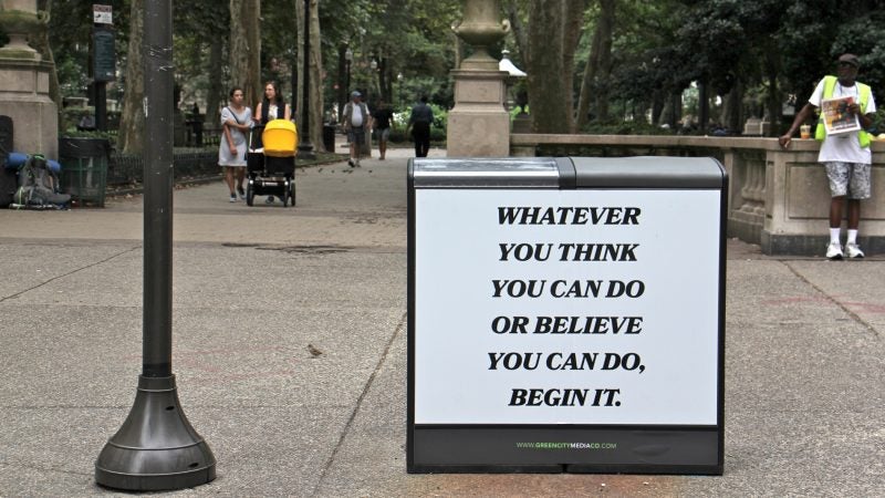 Saeed Ferguson's rendition of an inspirational quote stands out on a trash can at the entrance to Rittenhouse Square. (Emma Lee/WHYY)