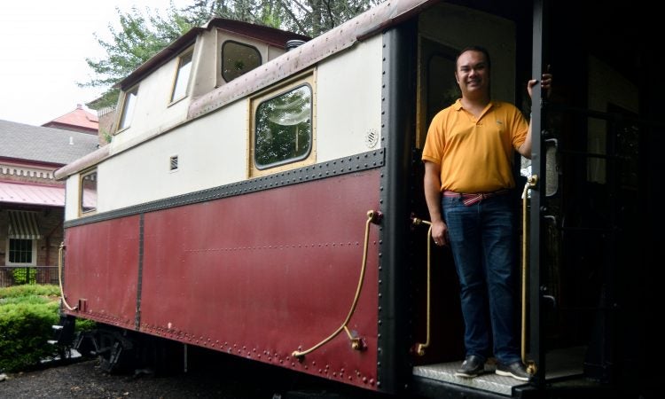 Mayor Peter Ursucheler stands on the back of a stationary caboose, located at the former train station in Phoenixville, PA, on august 21, 2018. The Colombia Station currently houses an event venue. (Bastiaan Slabbers for WHYY)