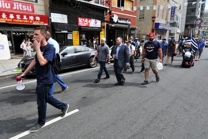 Fewer than twenty-five people participate in a Blue Lives Matter march from Independence Mall, trough Chinatown, toward Logan Square, on Saturday.  (Bastiaan Slabbers for WHYY)