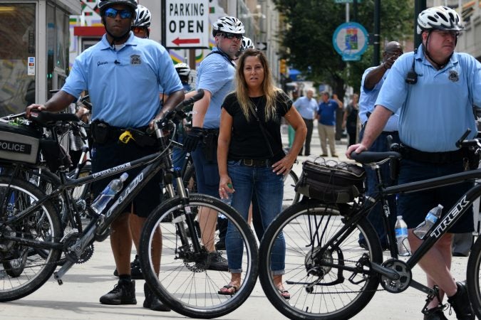 Participant in a Blue Lives Matter march watches from behind a bike line at Broad and Arch Streets, on Saturday. (Bastiaan Slabbers for WHYY)