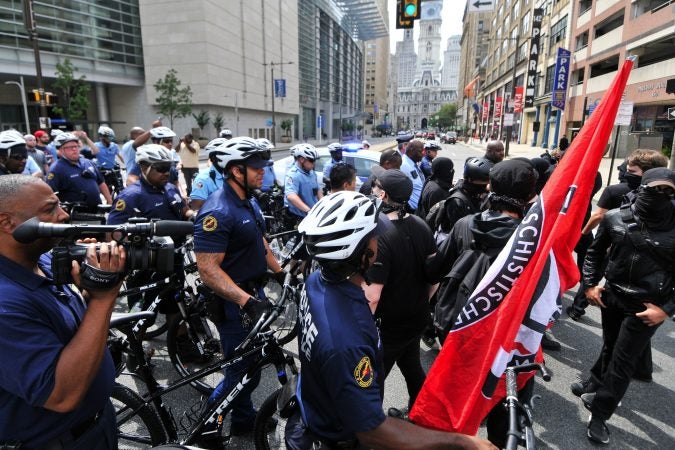 Police come between counter-protestors (on the right) and a Blue Lives Matter march, as it attempts to cross over Broad Street, towards Logan Square, on Saturday. (Bastiaan Slabbers for WHYY)
