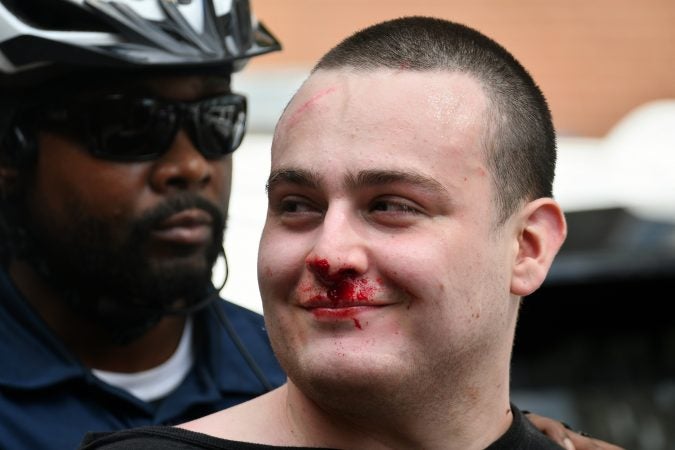 Counter-protester is seen taken into custody as police detains multiple people as a small group of Blue Lives Matter protestors attempts to march in Center City on Saturday.  (Bastiaan Slabbers for WHYY)