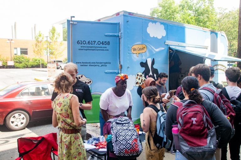 Jodi Risper, regional director and organizer with NextGen, asks students at Temple University to fill out a survey in exchange for free Ben & Jerry's ice cream while encouraging them to register to vote. (Brad Larrison for WHYY)