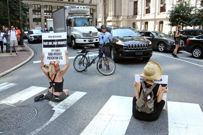 Protesters block streets around City Hall, calling for overdose prevention sites in Philadelphia. (Emma Lee/WHYY)