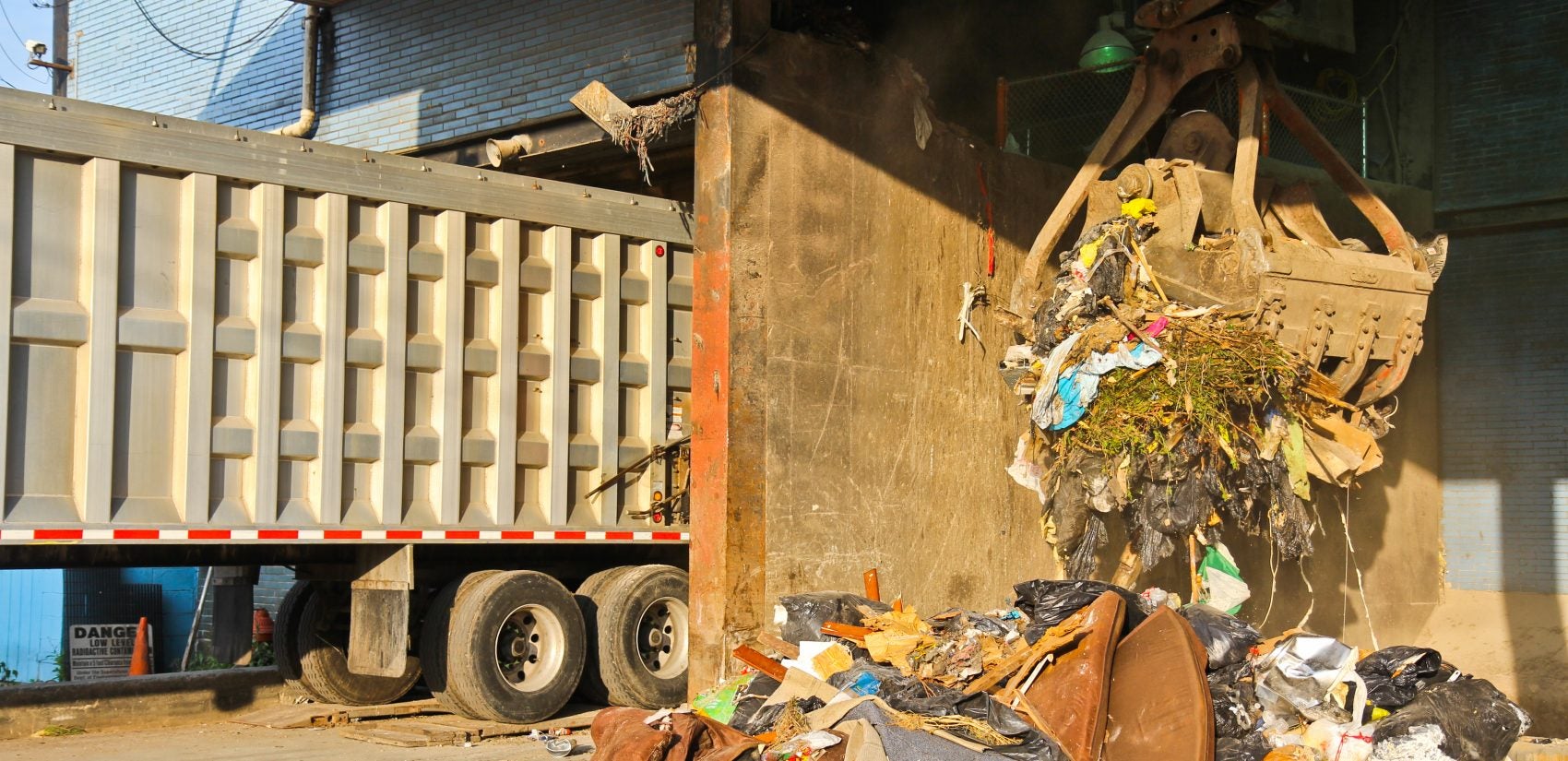 A claw grabs trash at the Northwest Transfer Station in Roxborough. (Kimberly Paynter/WHYY)