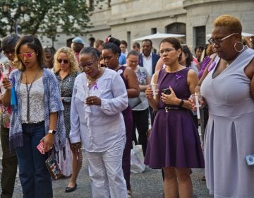 Colleagues, friends, and family of Linda Rios remember her at a candlelight vigil at City Hall courtyard Thursday afternoon. (Kimberly Paynter/WHYY)