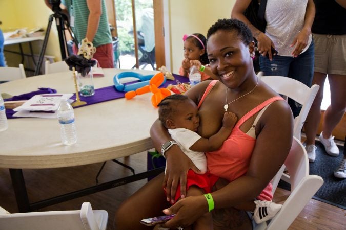 Keisha Anderson breastfeeds 7-month-old Timothy at the Big Latch event in Philadelphia. (Kimberly Paynter/WHYY)