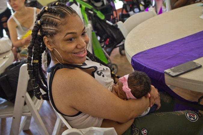 Marissa Cooley breastfeeds 7-week-old Kynsley at the Big Latch event in Philadelphia.  (Kimberly Paynter/WHYY)